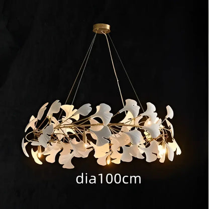 A modern white orchid decorbites ginkgo chandelier with delicate white ginkgo leaves and gold-toned ceiling mount