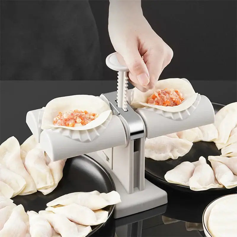 Gray plastic dumplings press with silver metallic handle and spiral mechanism for double head ravioli maker kitchen tool