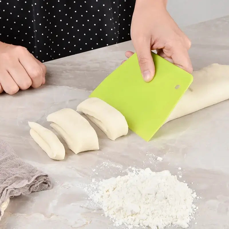 Bright green silicone dough cream cake cutter spatula with rounded handle and hanging hole for kitchen baking use