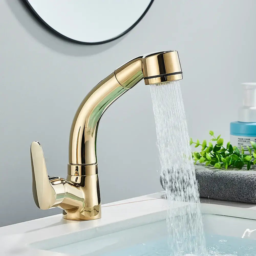 Gold-colored sleek bathroom sink faucet with curved spout and pull-out spray head for modern bathroom sink use