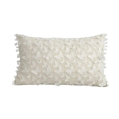 Cream-colored cushion cover with raised white plum blossom butterfly appliqués and pom-pom trim for decorbites 3d plum decor