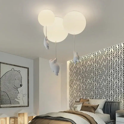 White polar bear ceramic pendant light with soft-glowing balloon shape and plush animal figures for kids bedroom