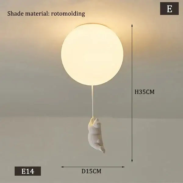 White polar bear ceramic pendant light with a soft white rotomolded lampshade and dangling cat figurine cord pendant
