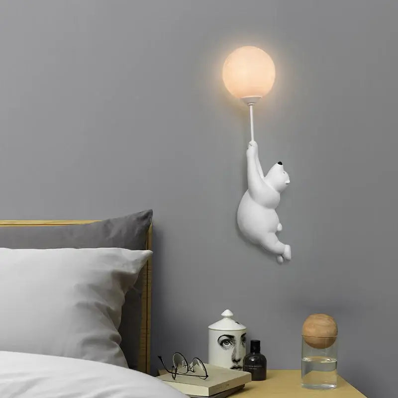 White polar bear night light holding a glowing spherical bulb ideal as a bear night light for kids bedroom