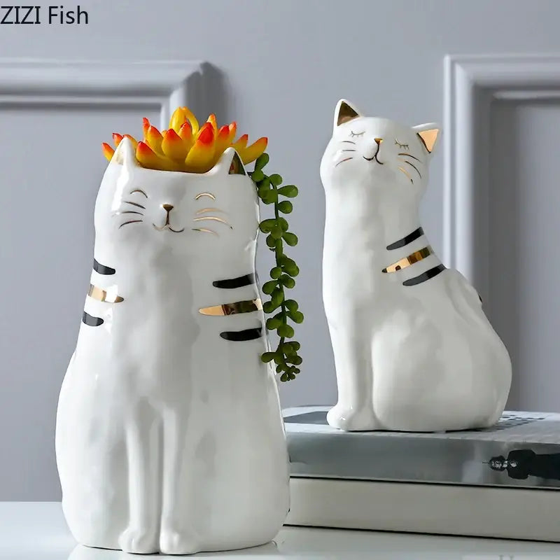 White porcelain decorbites cat vase with gold trim holding a succulent plant for living room decor