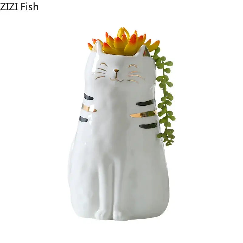 White porcelain cat vase with gold trim featuring black and gold stripes holding colorful succulents decorbites cat vase