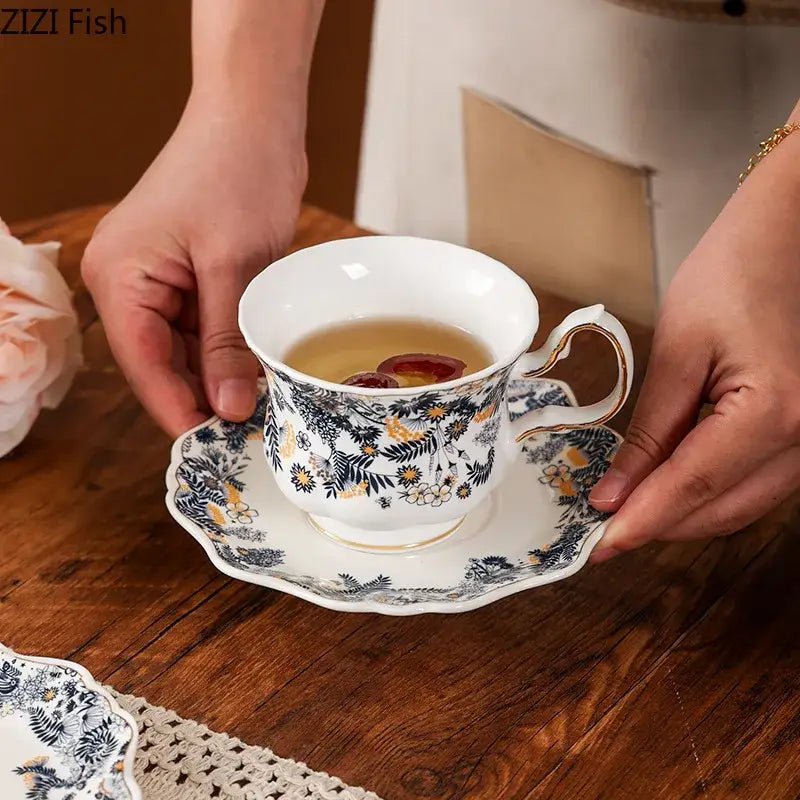 White porcelain classic tea cup set with scalloped edges and blue black gold floral patterns for dining room use