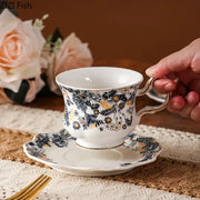 White porcelain classic tea cup set with navy blue and gold floral patterns and scalloped edges for dining room use