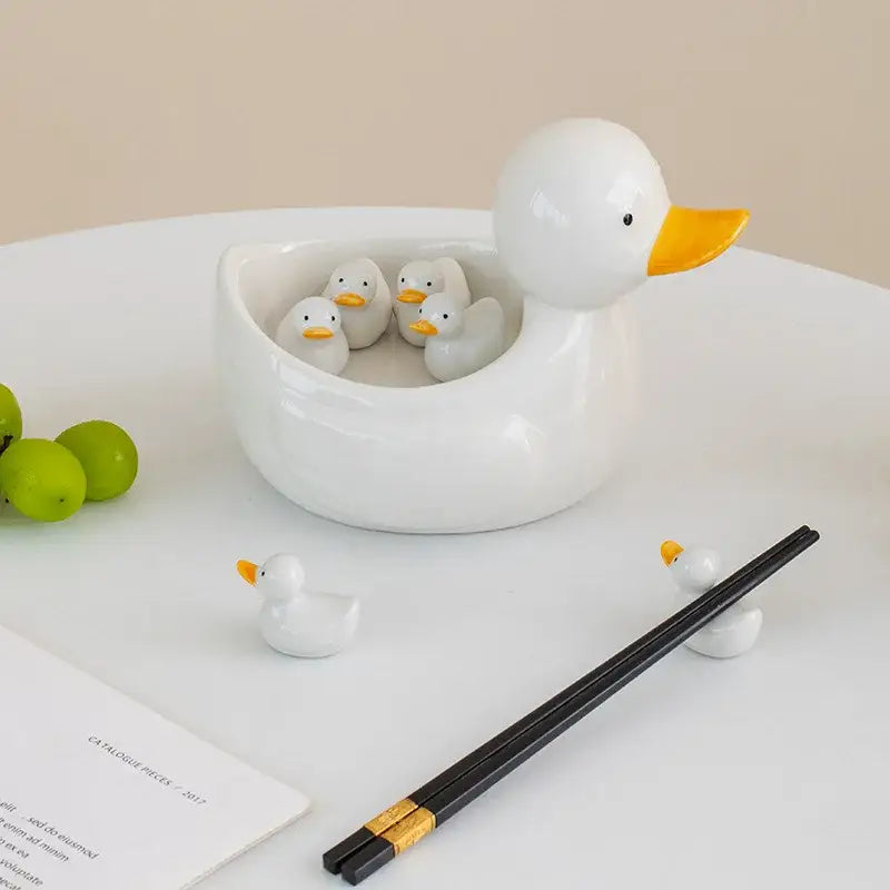 White porcelain duck chopstick holder tray ceramic dish in duck shape with yellow beak holding four smaller ducks inside
