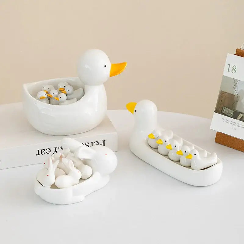 White porcelain duck chopstick holder tray ceramic dish with glossy finish and yellow beak holding small ducks