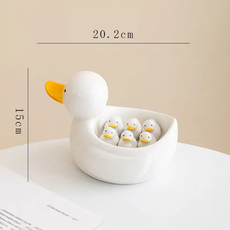 White porcelain duck chopstick holder tray featuring a ceramic white duck bowl with five smaller ducks inside