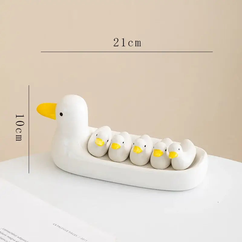 White porcelain duck chopstick holder tray ceramic dish with white duck and yellow-beaked ducklings nestled in belly