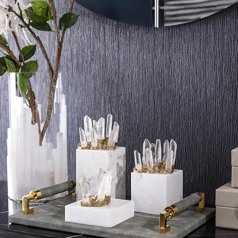 Three white marble bases holding clear quartz crystal stone with golden accents for living room decor stone marble ornament