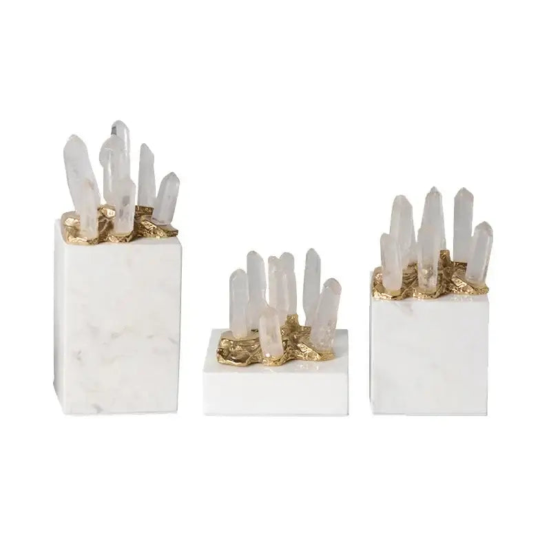 Set of three white crystal stone marble bases with gold accents and clear quartz clusters for living room decor