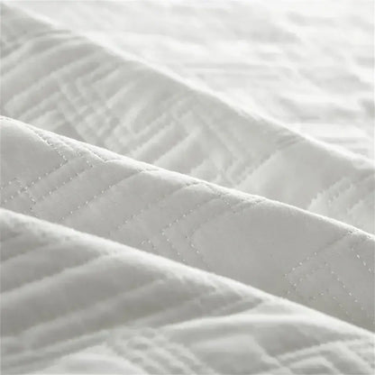 White quilted cotton coverlet bedspread set with subtle textured pattern and fine stitching for bedroom decorbites decor
