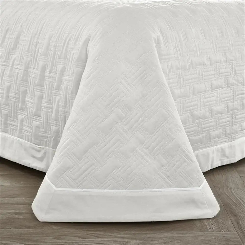White quilted cotton coverlet bedspread set with subtle woven texture and neatly finished hem for bedroom decorbites decor