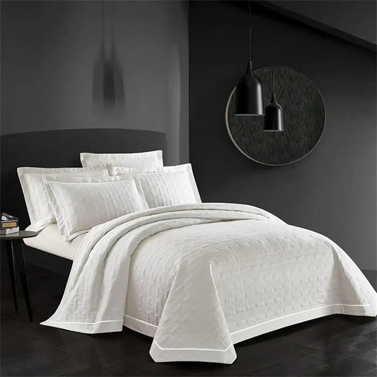 White quilted cotton coverlet bedspread set with subtle woven texture and crisp edges for bedroom decorbites decor