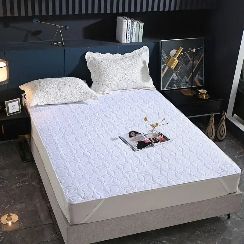 White quilted bed protector pad with diamond star pattern designed as a waterproof bed protector for bedroom use