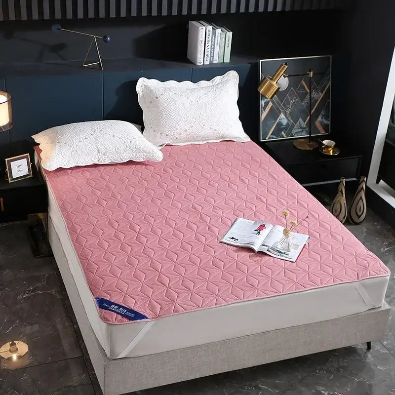 Pink quilted bed protector pad with diamond pattern designed as a waterproof bed protector for bedroom use