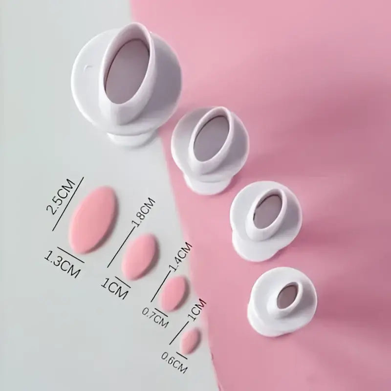White plastic oval cake decorating cookie cutters with measurement markings on pink and white background for star cake decorating