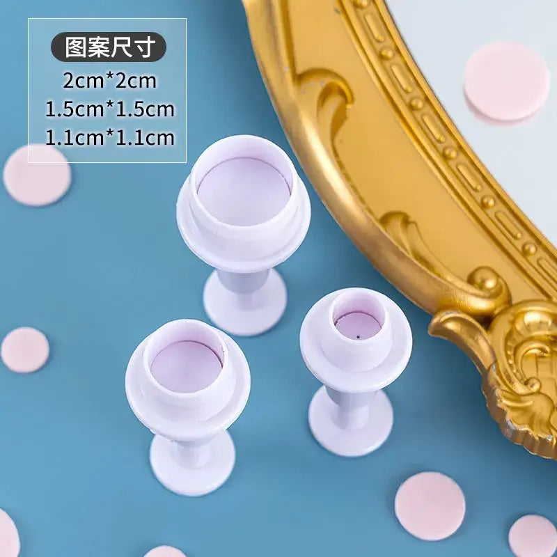 White plastic fondant cake decorating tools with fluted cup tops and slender stems for star cake decorating cookie use