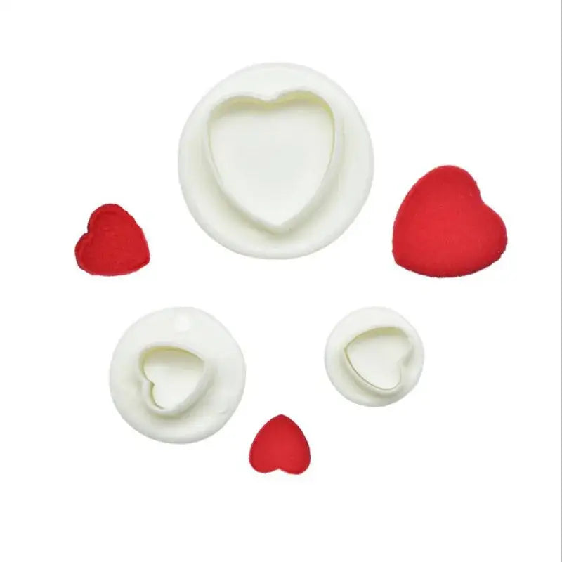 Set of white heart shaped cake decorating cookie cutters with red silicone hearts for star cake decorating use