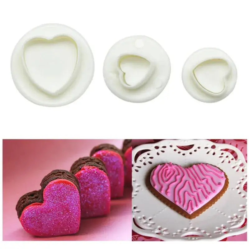 Set of three white heart shaped cake decorating cookie cutters with examples on decorated cookies and chocolate hearts