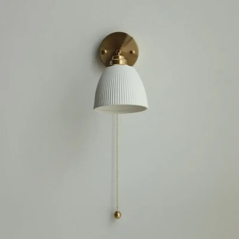 White ribbed ceramic led wall sconce with brass hardware and pull chain for bedroom by decorbites ceramic led