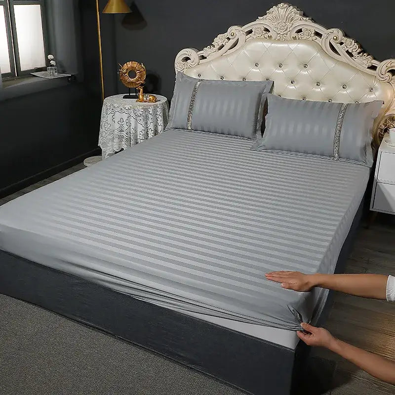 Gray striped bed sheet with subtle vertical stripes and matching pillowcases in a white satin bedding set with cozy solid decorbites cozy solid color trim