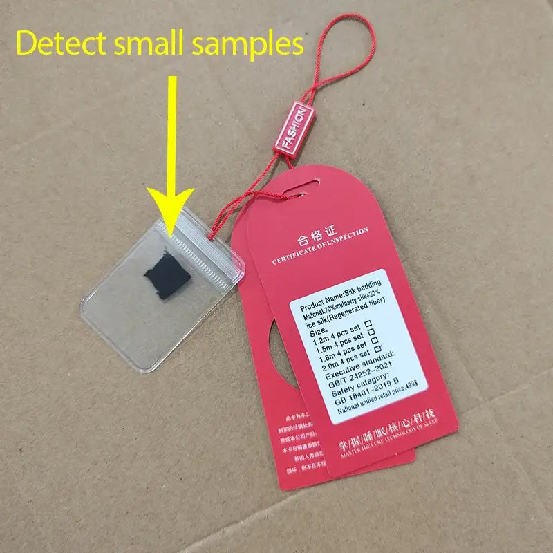 Red plastic tag with white text and red string loop displaying chinese and english details for white satin silk blend duvet cover set