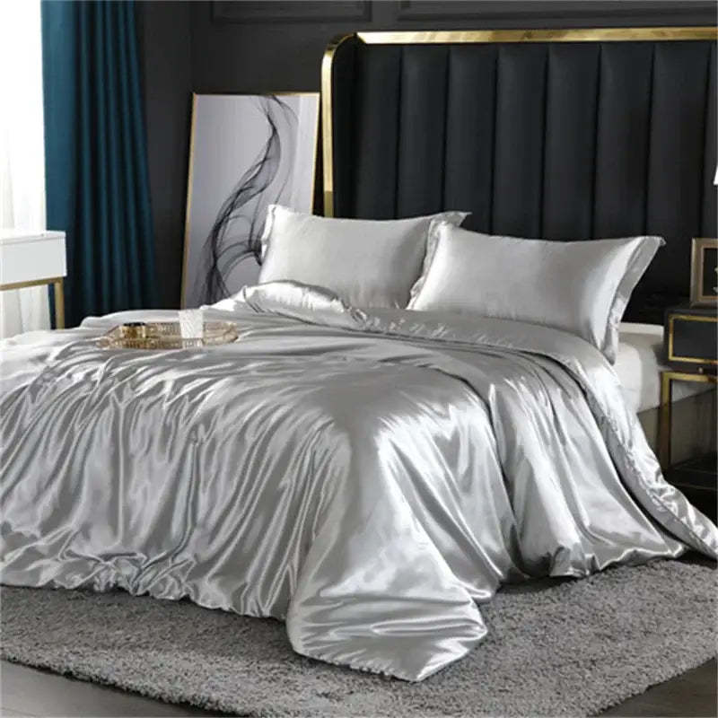 Silver satin silk blend duvet cover set with glossy reflective finish and matching pillowcases for bedroom use