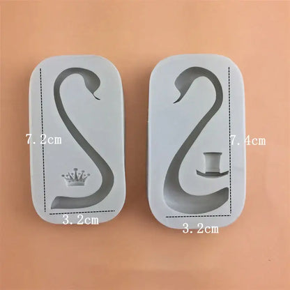 Two white silicone cake molds shaped like swans with crown and top hat for swan neck decorbites 3d wings decoration
