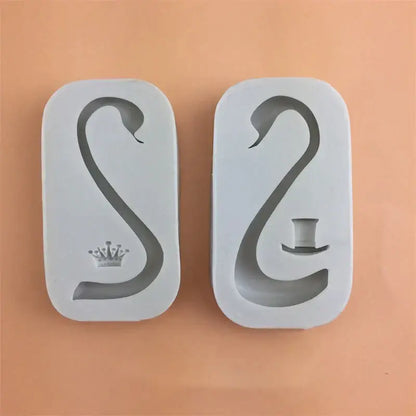 Two white silicone cake molds shaped like swans with swan neck design featuring decorbites 3d wings decor elements