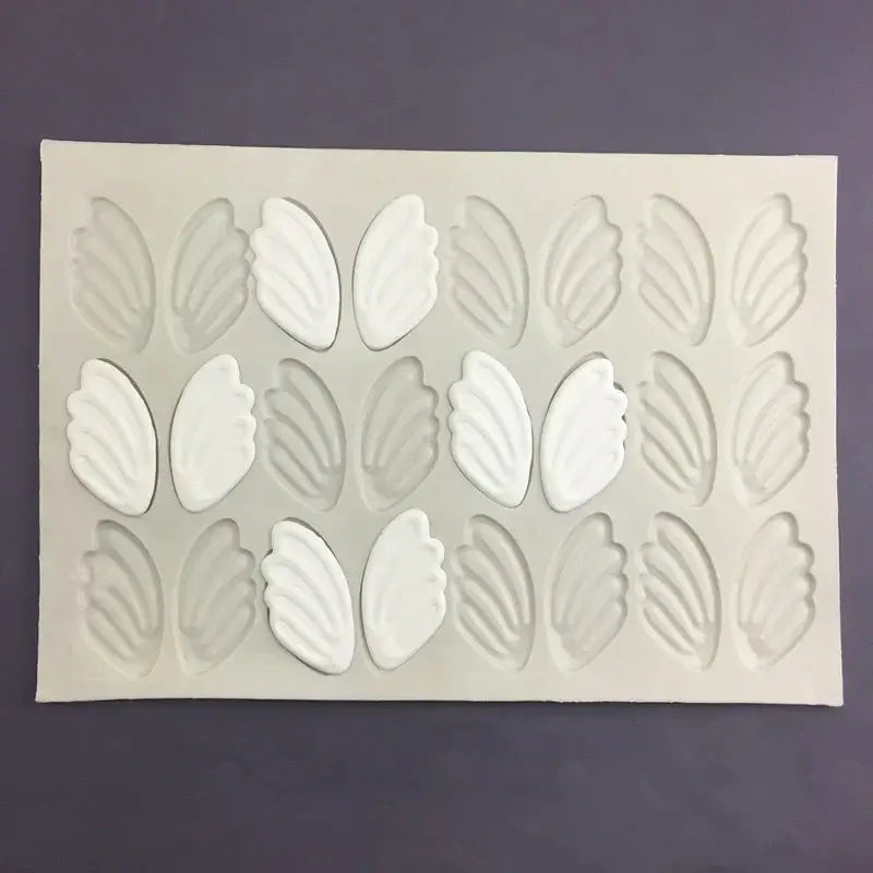 White silicone cake mold with three rows of detailed swan neck decorbites 3d wings cavities for decoration