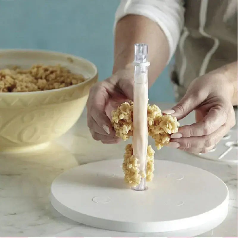 Clear plastic cylindrical layer cake frame kit with transparent top for shaping golden brown rice crispy treats