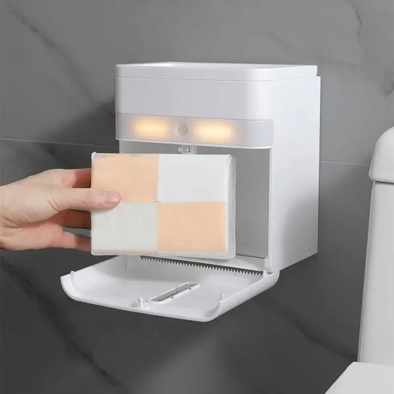 White plastic wall-mounted smart sensor toilet paper holder with induction light and pull-out tray holding checkered paper towels