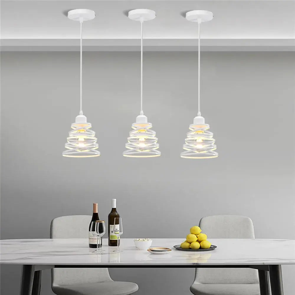 Three white pendant lights with spiral glass shades feature decorbites iron cage ring design for kitchen decor