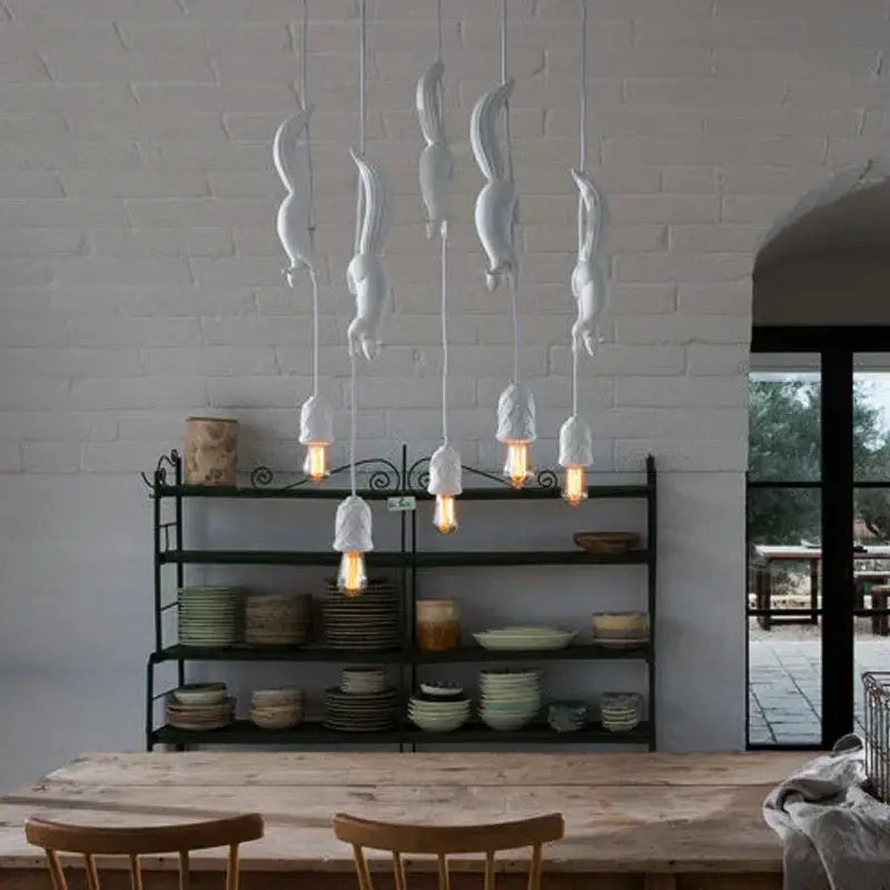 White ceramic squirrel pendant light with exposed filament bulbs as a decorative focal point for bedrooms