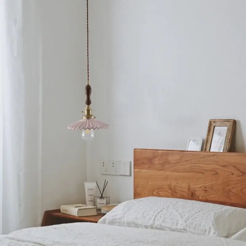 A delicate pink glass pendant light with brass fixture and dark wooden cord for decorbites ceramic led hanging decor