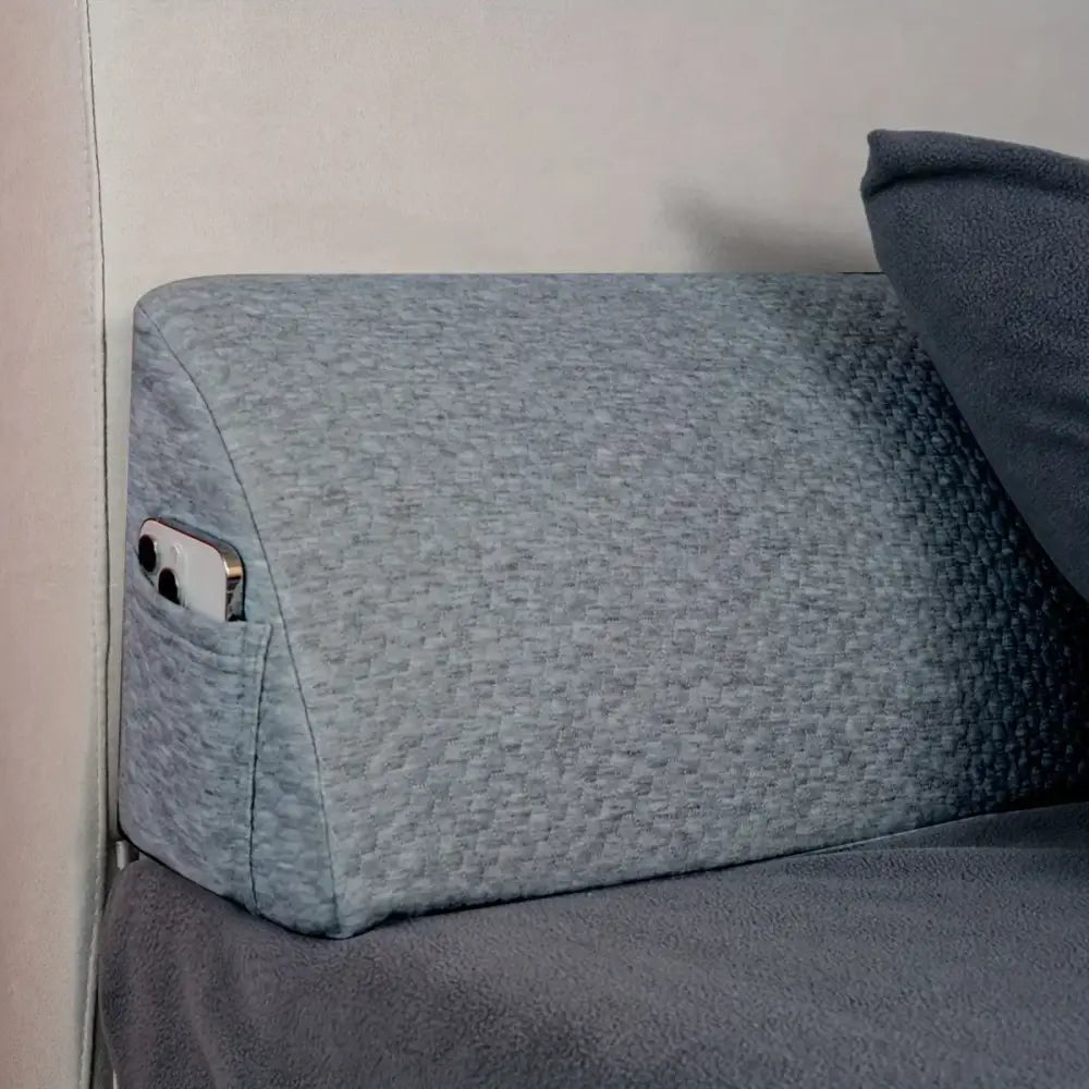 Gray textured fabric pillow wedge with built-in pocket holding smartphone for bedroom mattress gap filler decorbites headboard pillow wedge