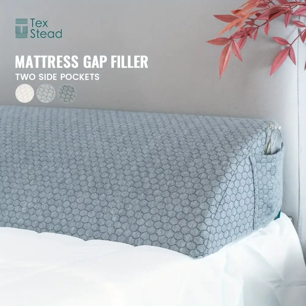 Gray hexagonal-patterned DecorBites headboard pillow wedge mattress gap filler with two side pockets for bedroom use
