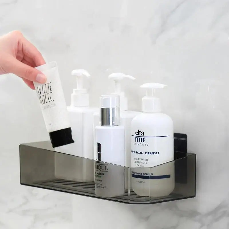 White and translucent transparent acrylic bathroom shelves wall storage rack holding various skincare products