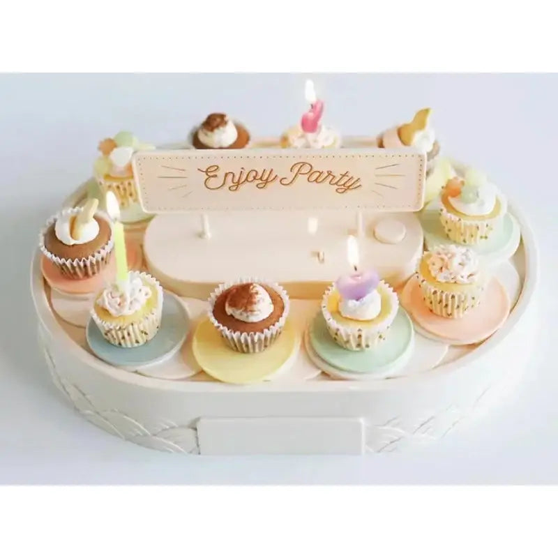 White two tiered rotating dessert table with pastel cupcake display and enjoy party sign for sushi machine dining room use