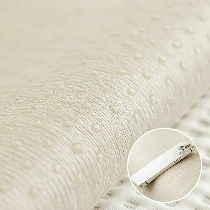 Beige textured white waffle weave ice silk sofa pad with subtle dotted pattern designed for comfort and moisture wicking
