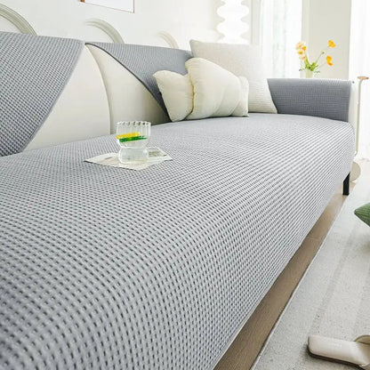Gray textured sofa cover with woven pattern and matching gray and white pillows in white waffle weave ice silk living room cushion