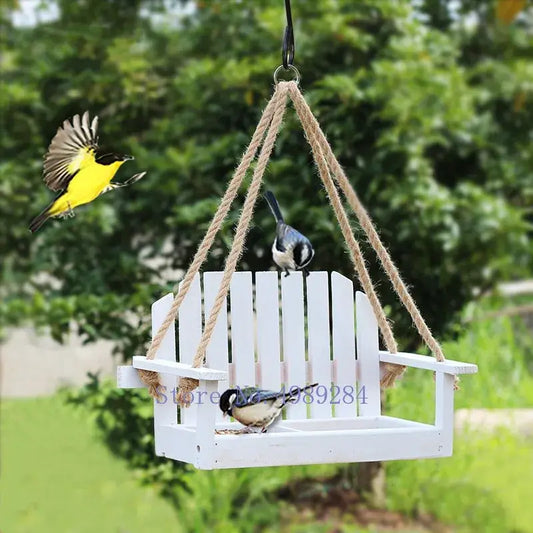 White wooden adirondack bird feeder chair hanging by thick natural twine for garden decor use