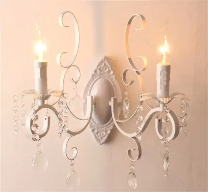 White wrought iron wall lamp with ornate scrollwork and dangling crystals decorbites crystal deco loft sconce