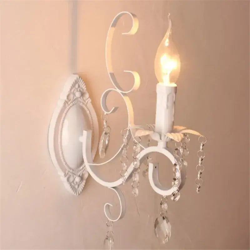 White wrought iron wall lamp with crystal deco loft droplets and candle-style bulb for bedroom decorbites crystal deco