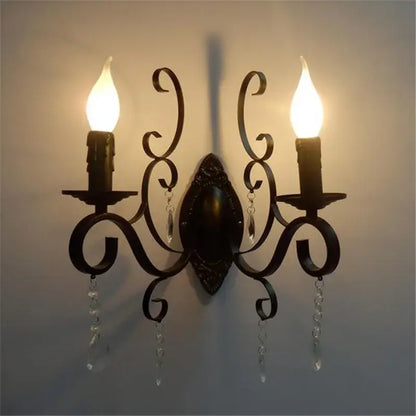 Dark bronze wrought iron wall lamp with ornate scrollwork and crystal deco loft accents featuring two candle bulbs