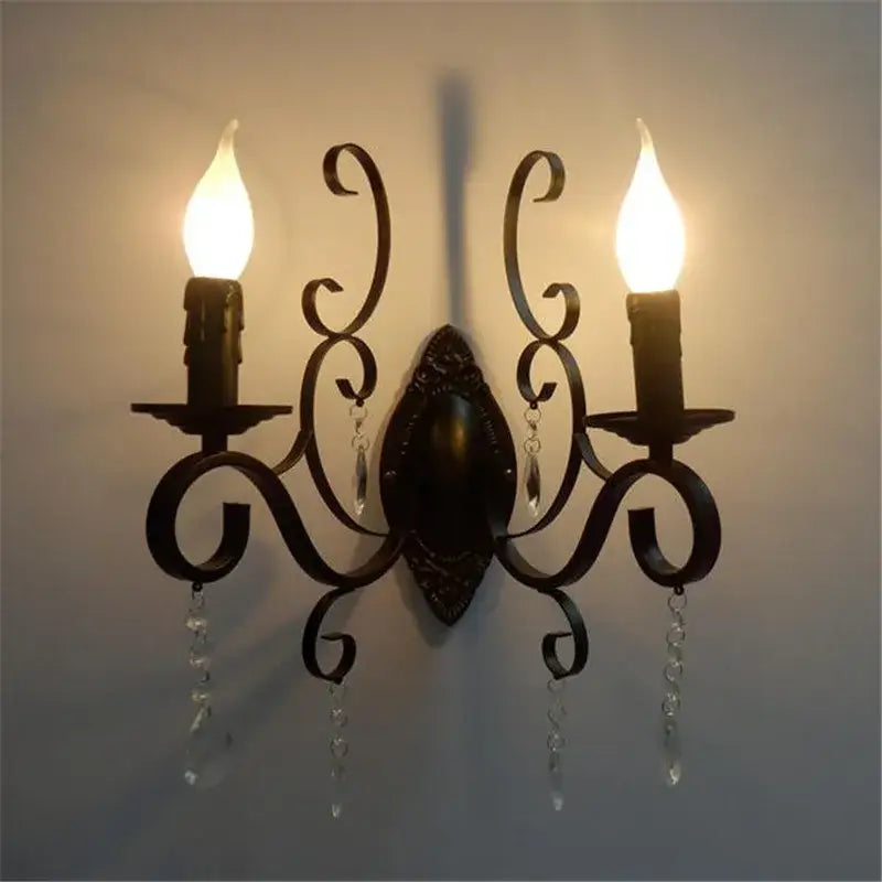 Dark bronze wrought iron wall lamp with ornate scrollwork and crystal deco loft accents featuring two candle bulbs